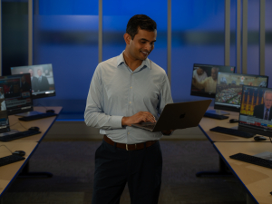 Shikhar Singh smiles while uses his computer in a computer lab 